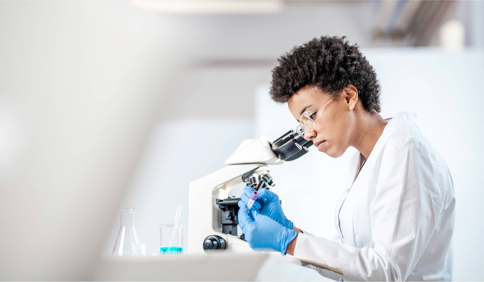 black female scientist working with microscope