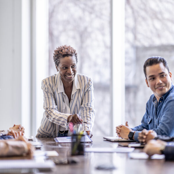 group of business professionals sit around a table