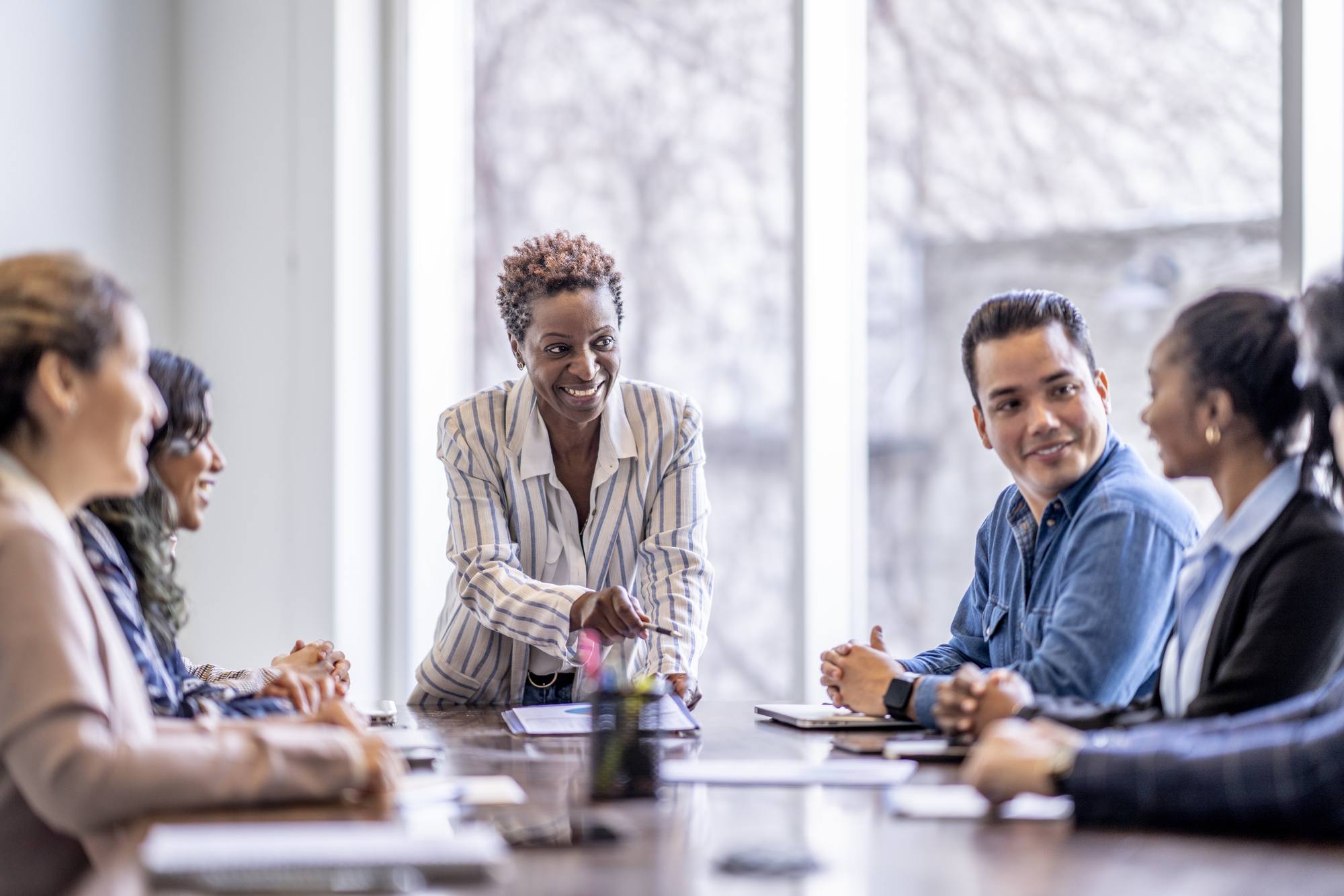 group of business professionals sit around a table