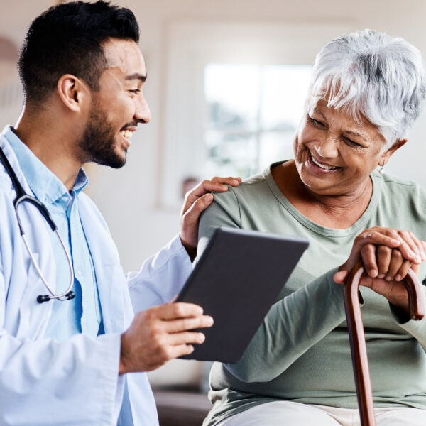 doctor sharing information on tablet with an older patient