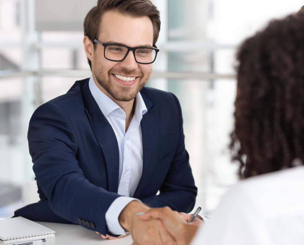 man in suit handshake with businesswoman