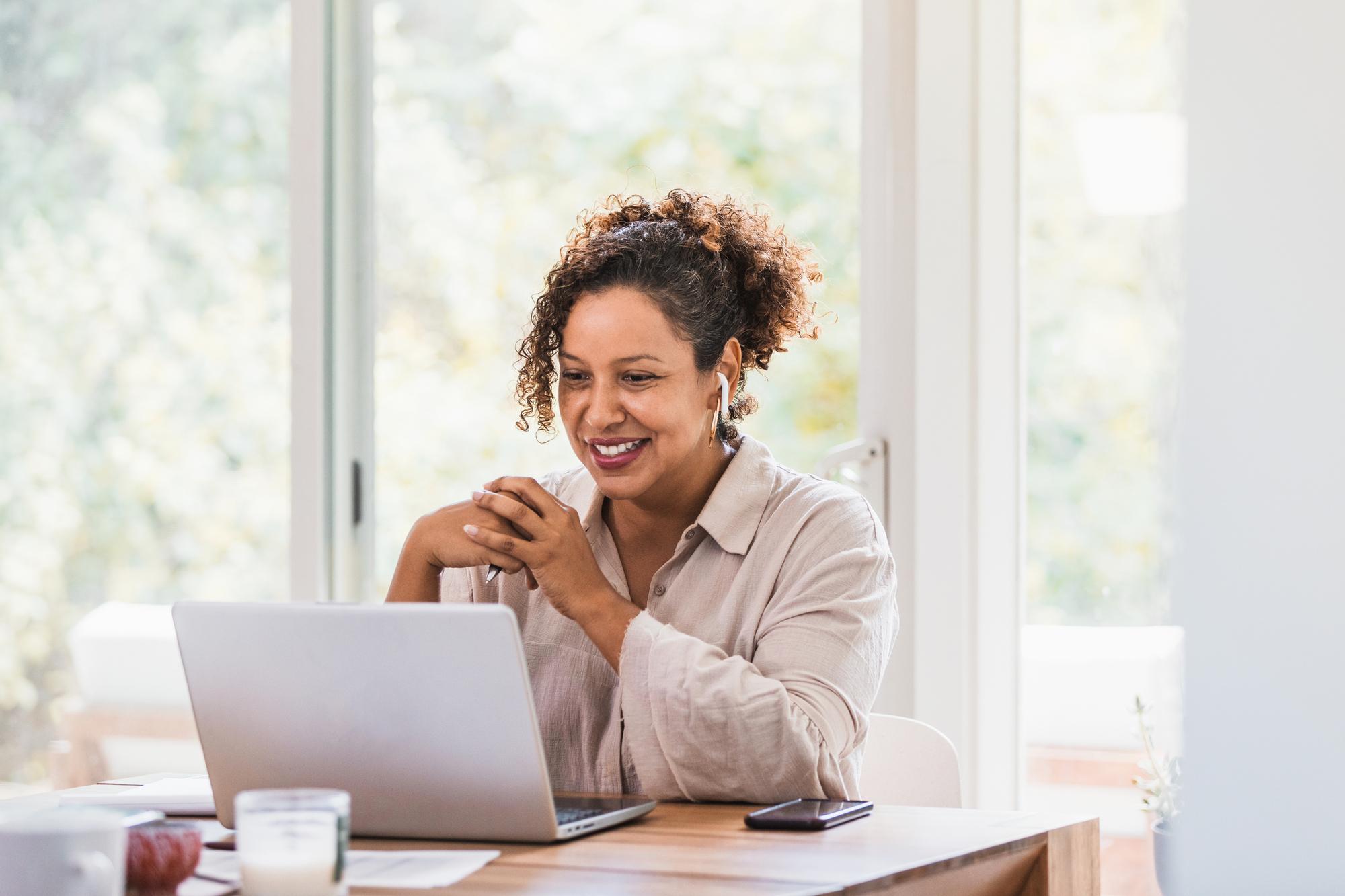 women wearing earbuds on a video conference