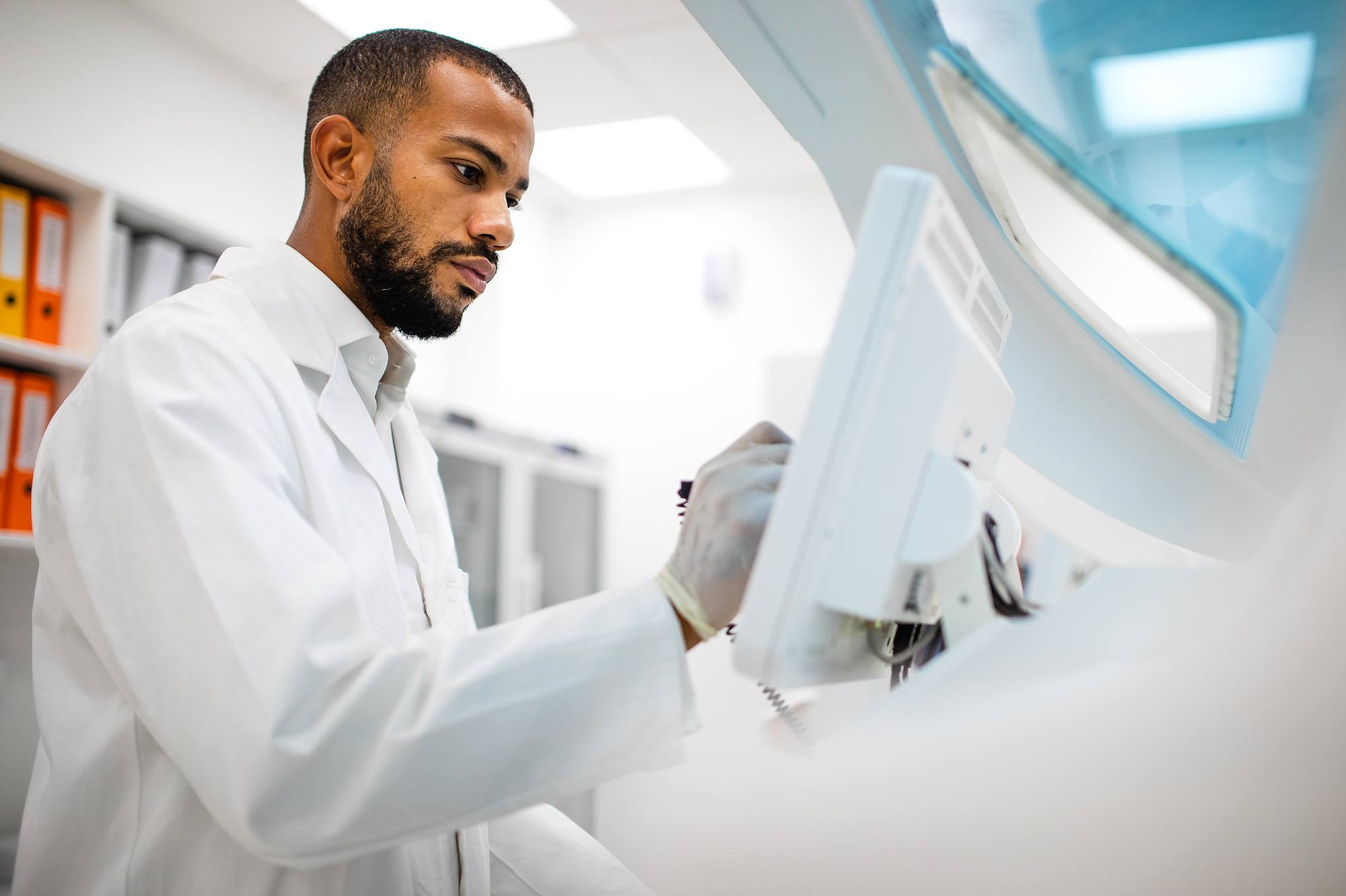 black male scientist on computer in lab