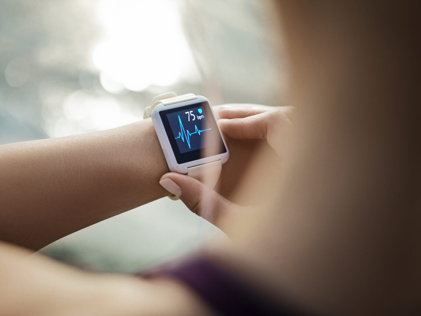 Woman Looking At Her Smart Watch for a pulse trace