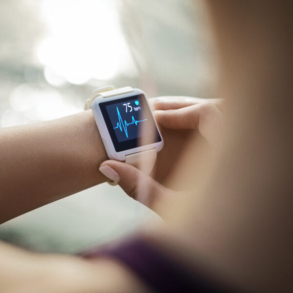 Woman Looking At Her Smart Watch for a pulse trace