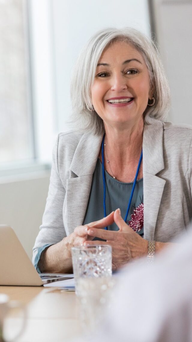 Businesswoman laughs with medical colleagues