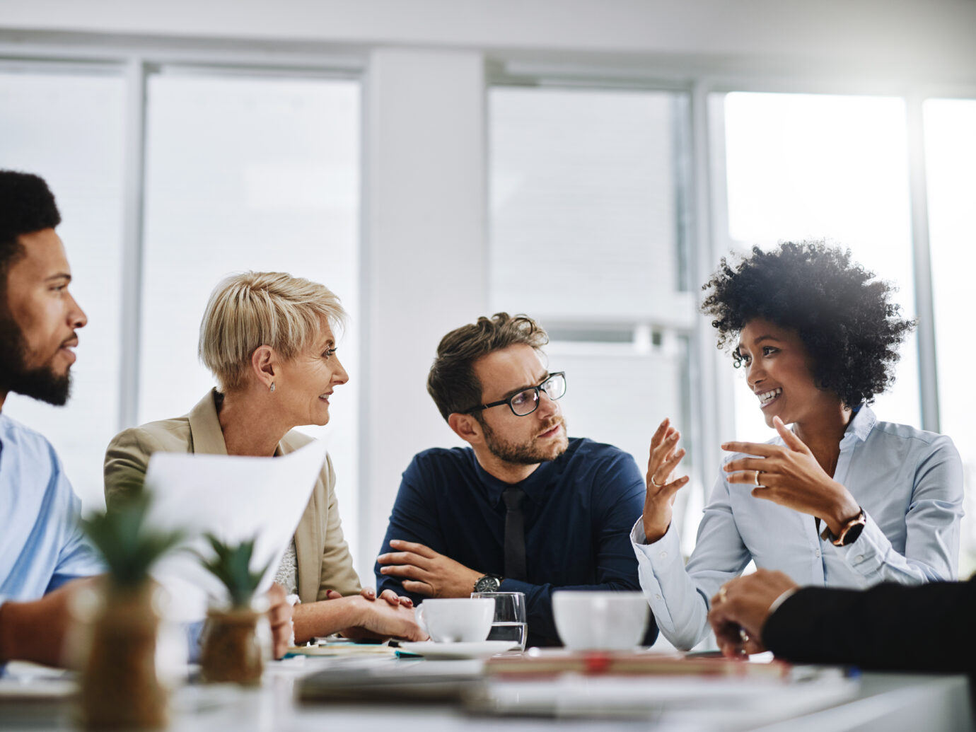 group of businesspeople sitting together in a meeting