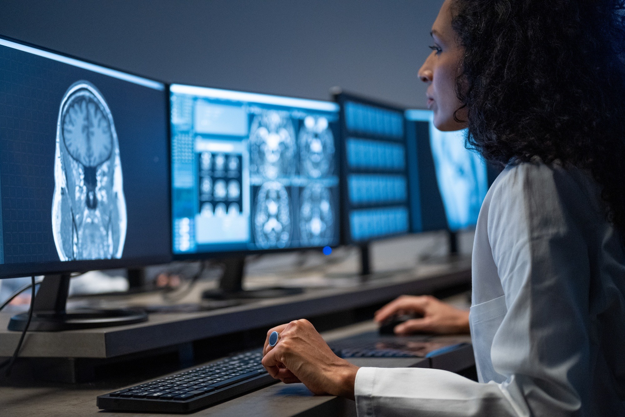 A doctor viewing a computer screen of scans