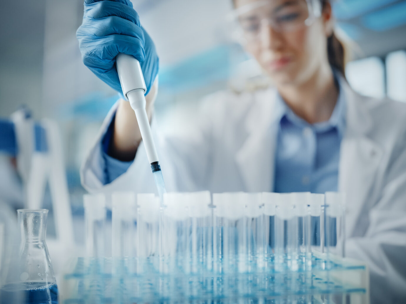 Female Scientist in Goggles Using Micro Pipette