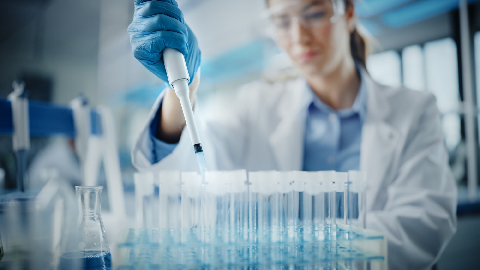 Female Scientist in Goggles Using Micro Pipette