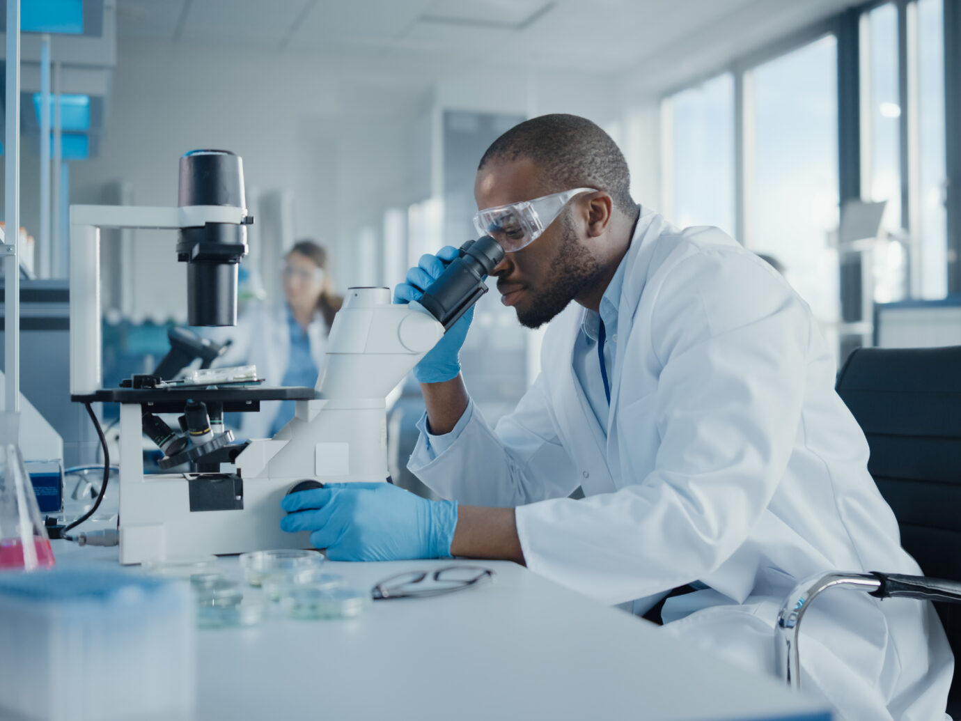 black male scientist working with microscope