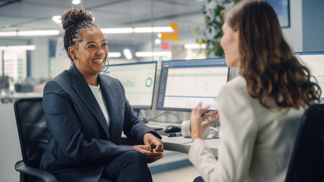 Two Female Colleagues Fondly Talk to Each Other