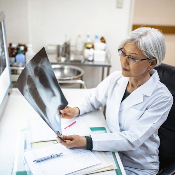 Doctor sitting at a desk viewing scans