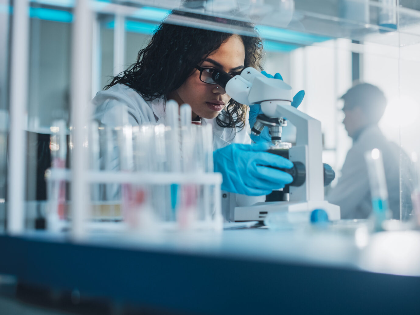 Black Scientist Looking Under Microscope