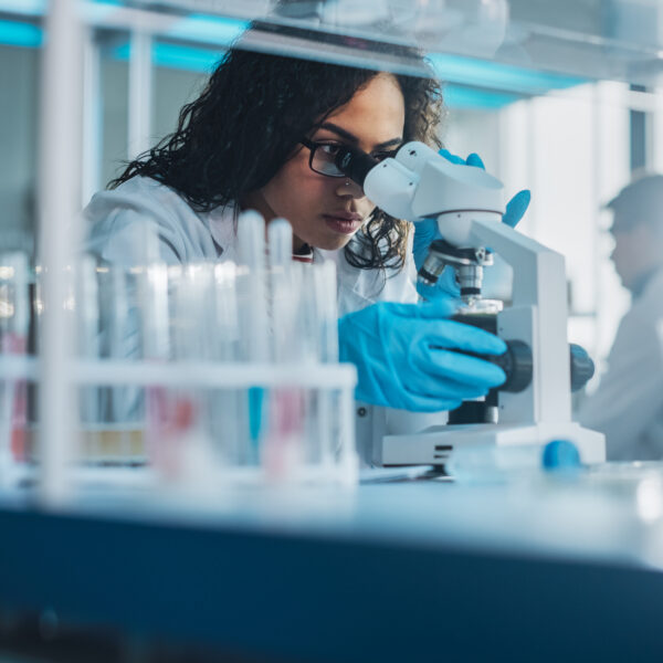 Black Scientist Looking Under Microscope