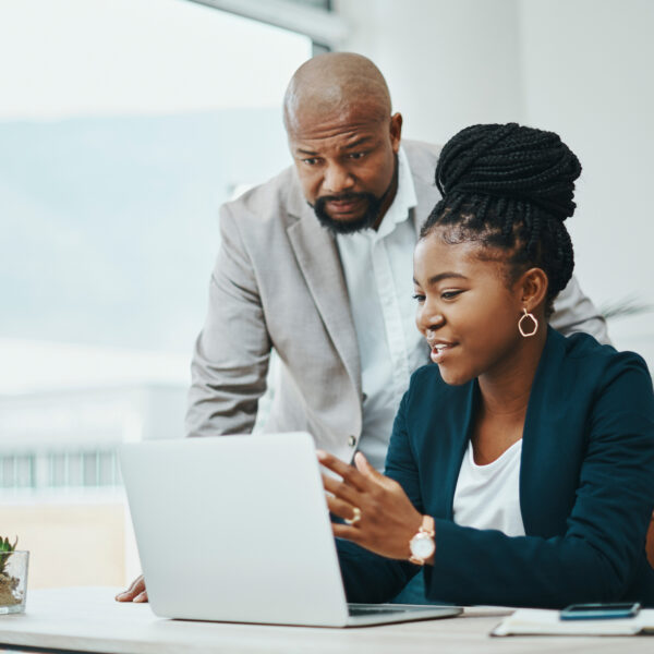 businessman and businesswoman using a laptop together