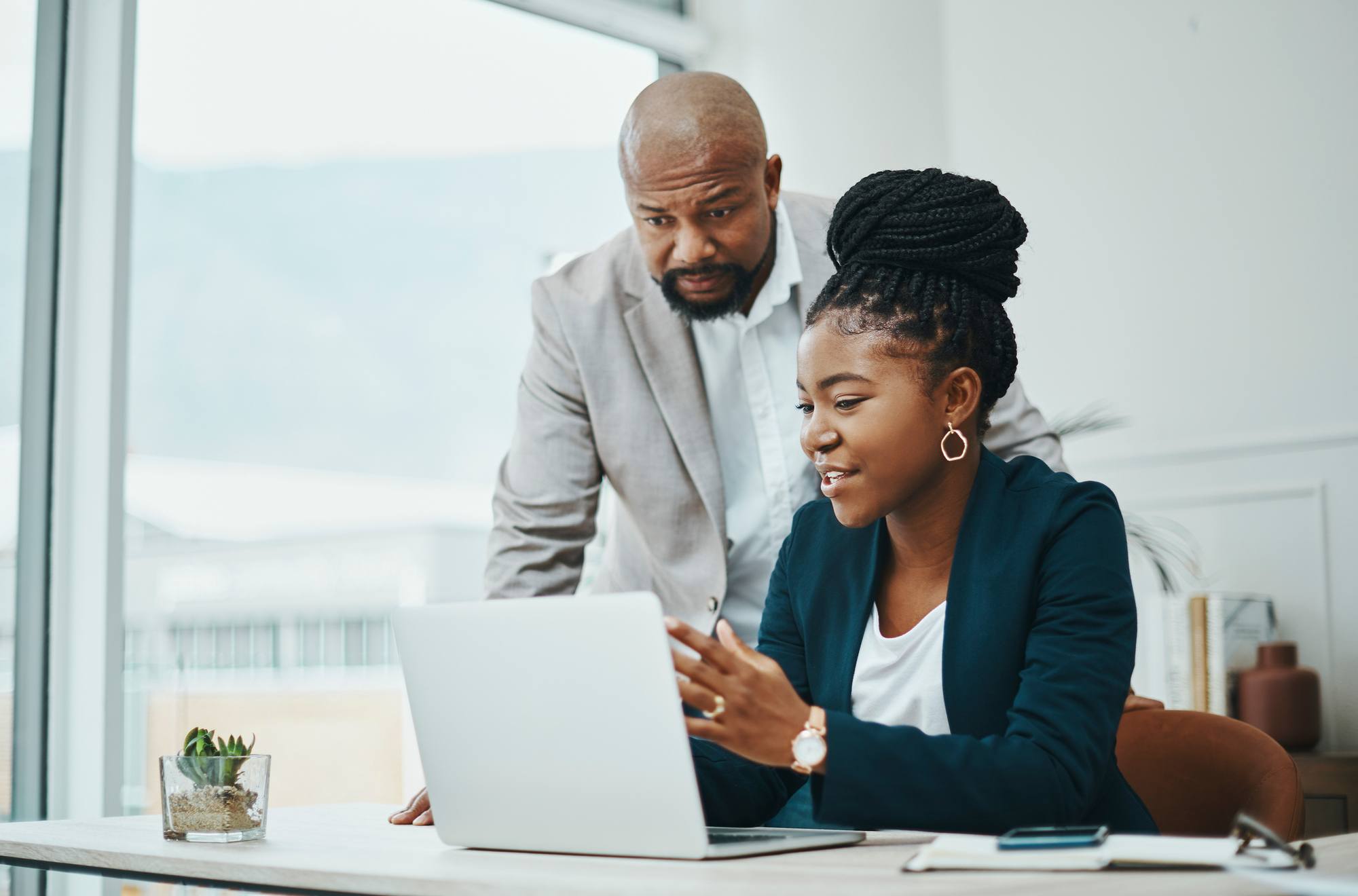 businessman and businesswoman using a laptop together