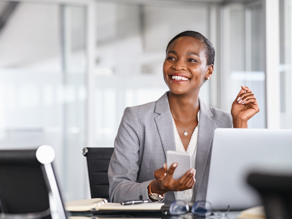 Smiling businesswoman looking up while working