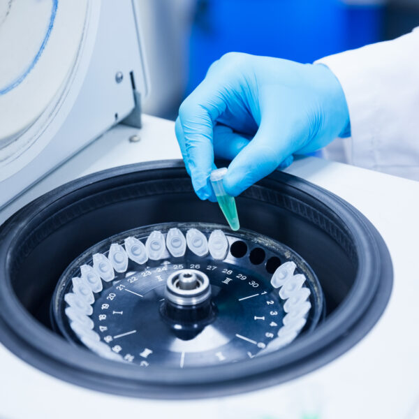 Close up of a chemist using a centrifuge in lab