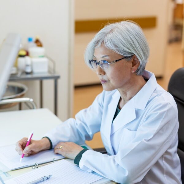 Doctor at a desk looking at a computer