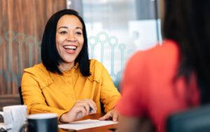 Woman speaking with a peer