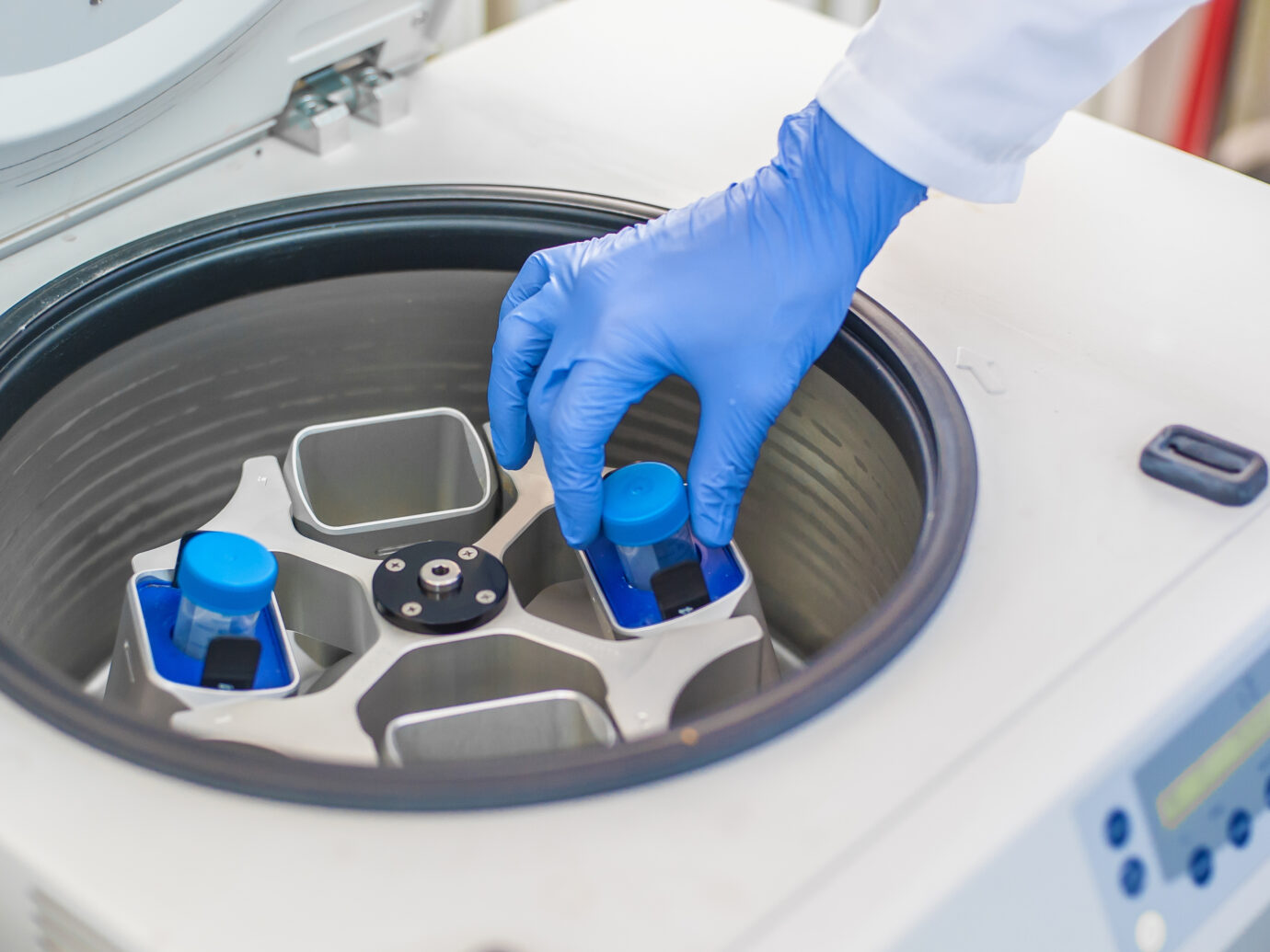 Technician loading a sample to centrifuge machine