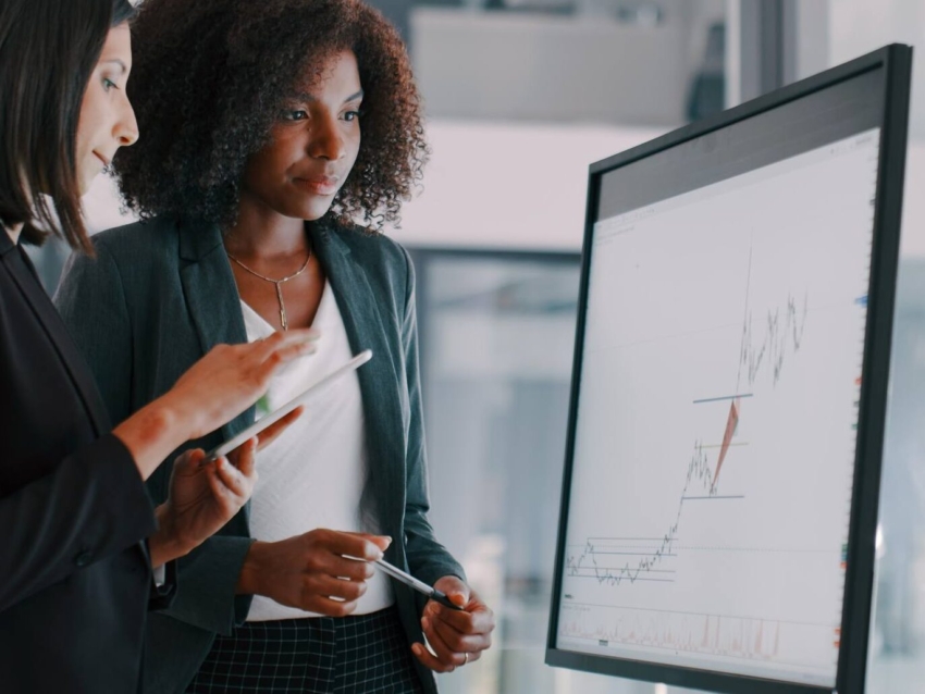 businesswomen using an interactive whiteboard