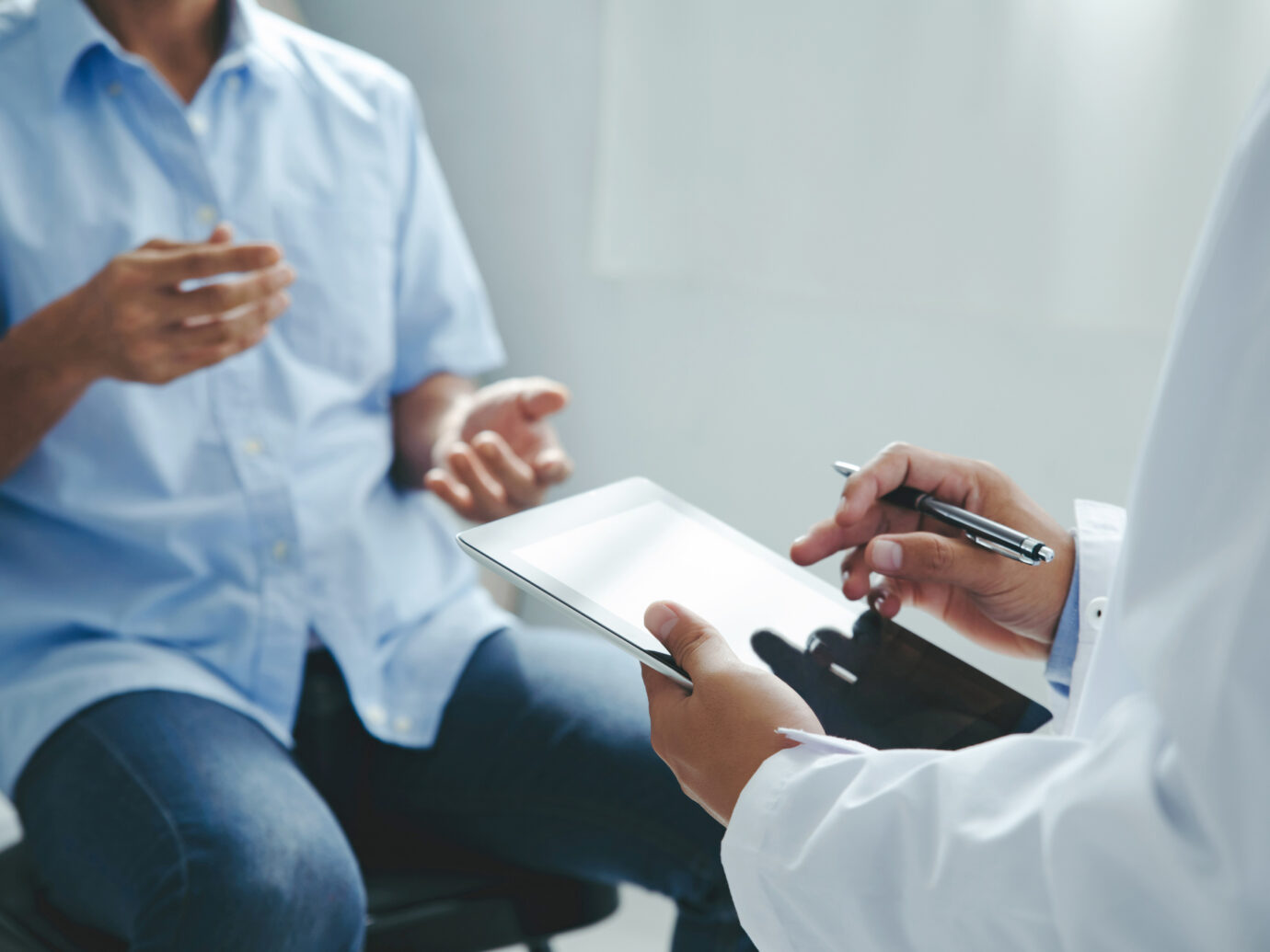 Doctor talking to patient explaining treatment