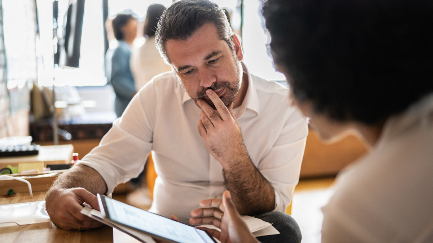 man looking at a digital tablet