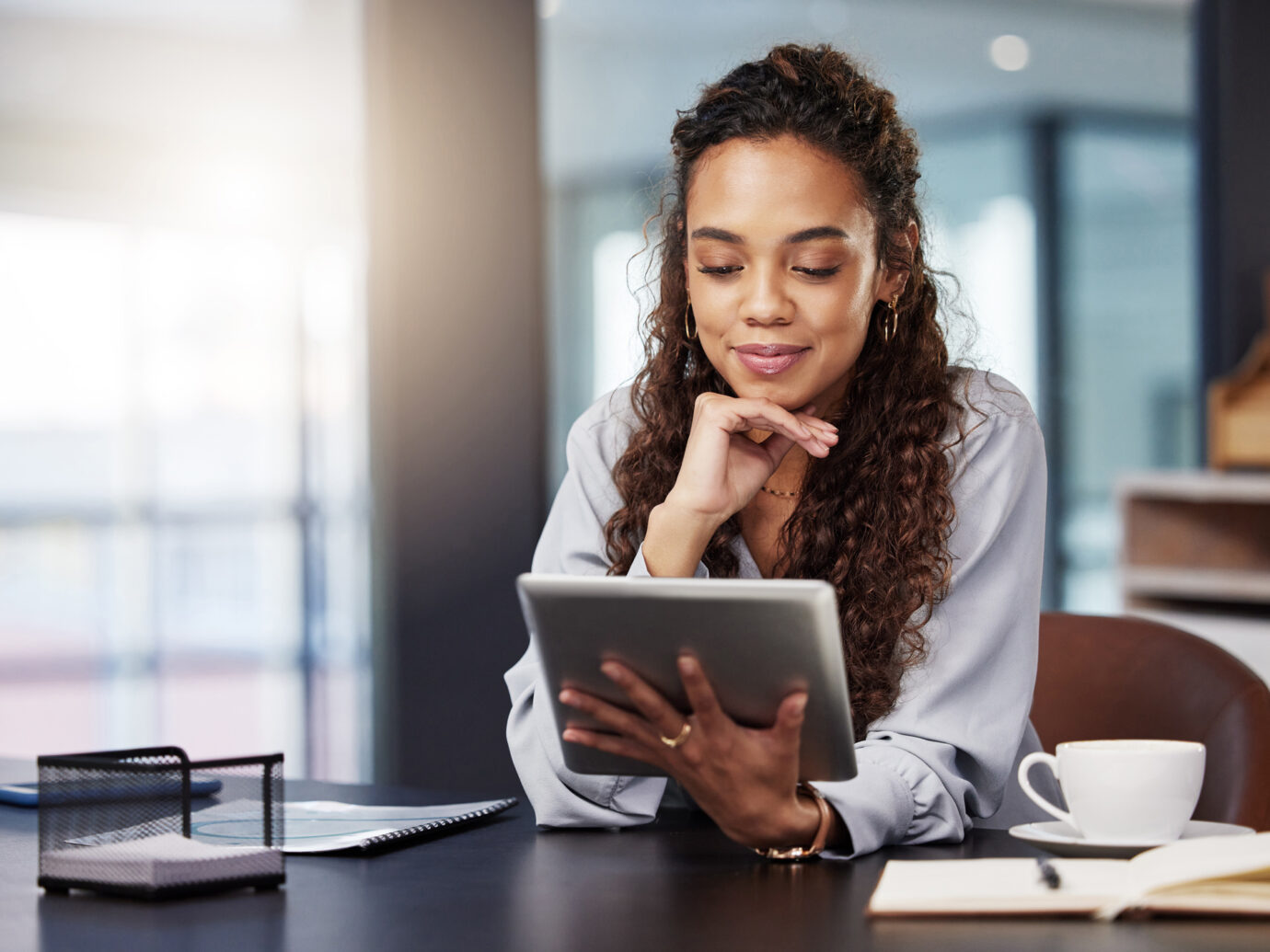 businesswoman using a digital tablet while at work