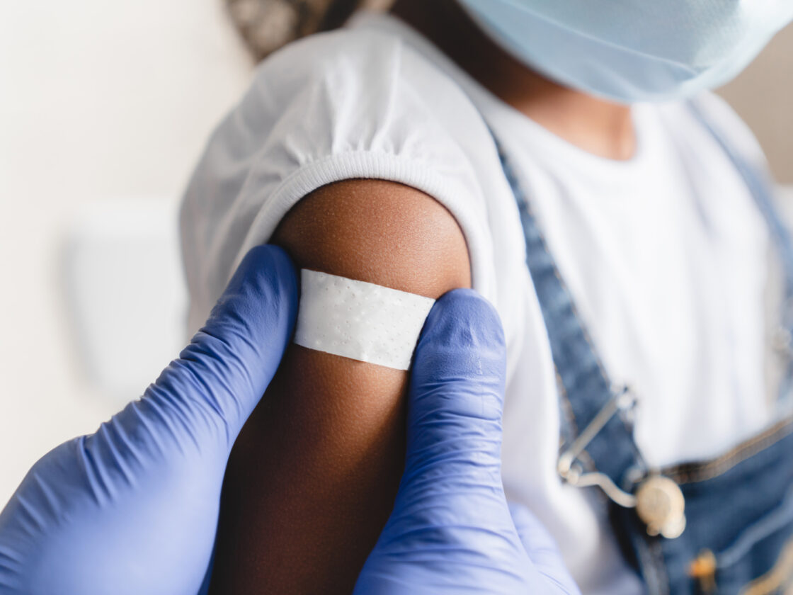 Nurse applying medical patch after injection