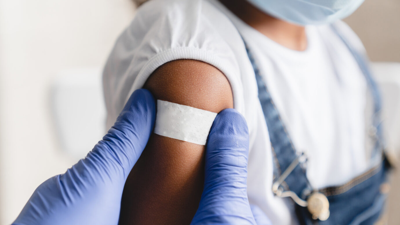 Nurse applying medical patch after injection