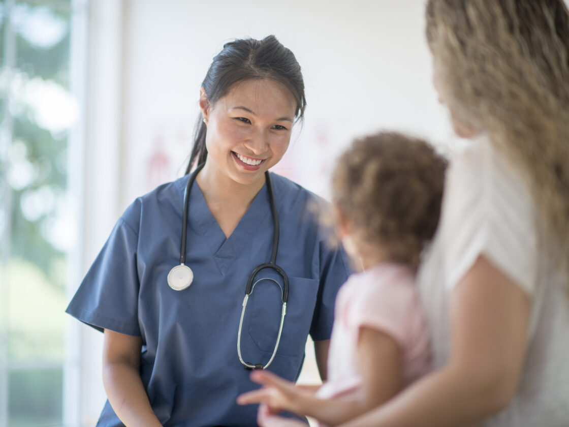 Nurse Speaking to a Mother and Child