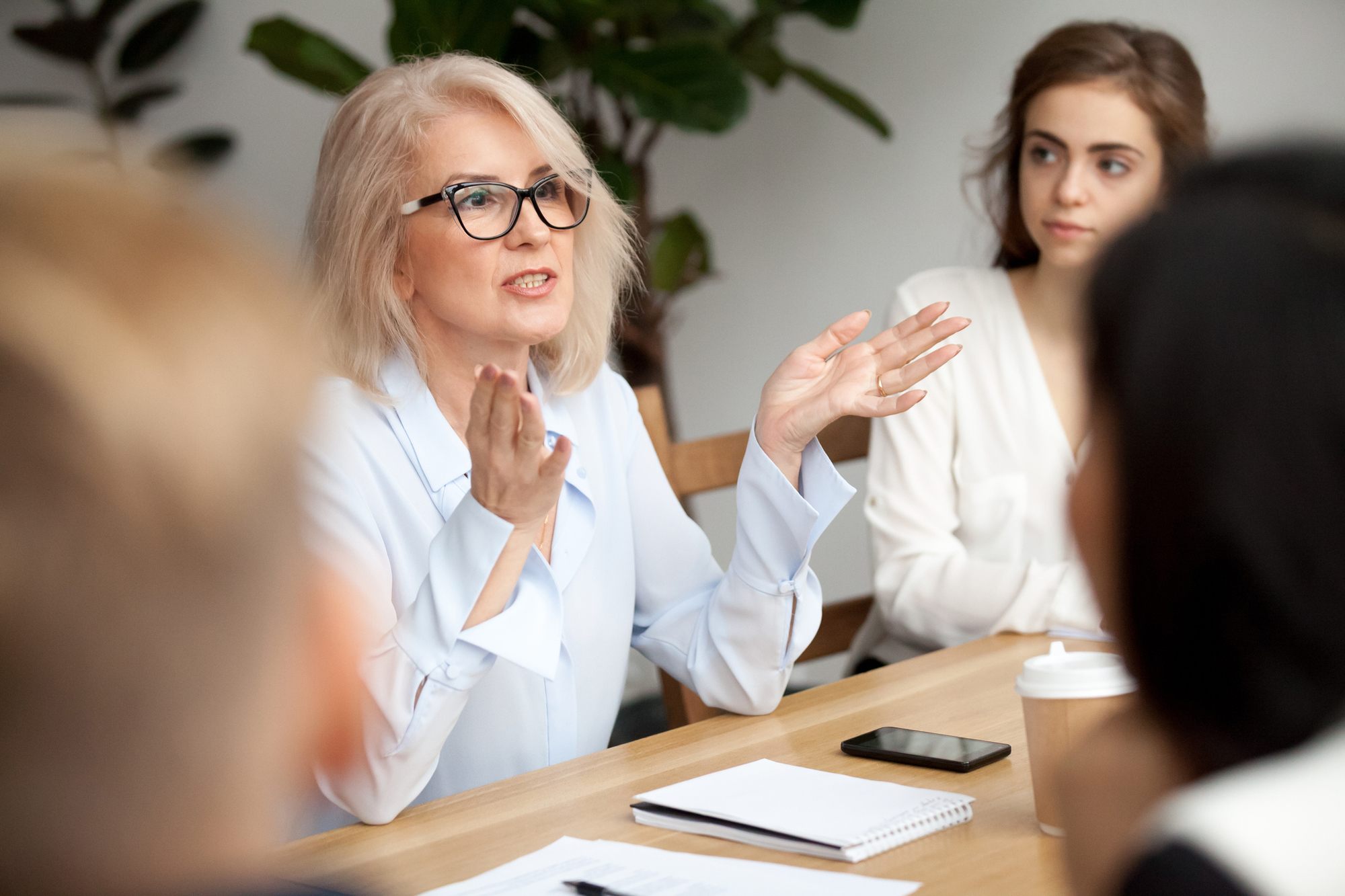 businesswoman speaking to young people