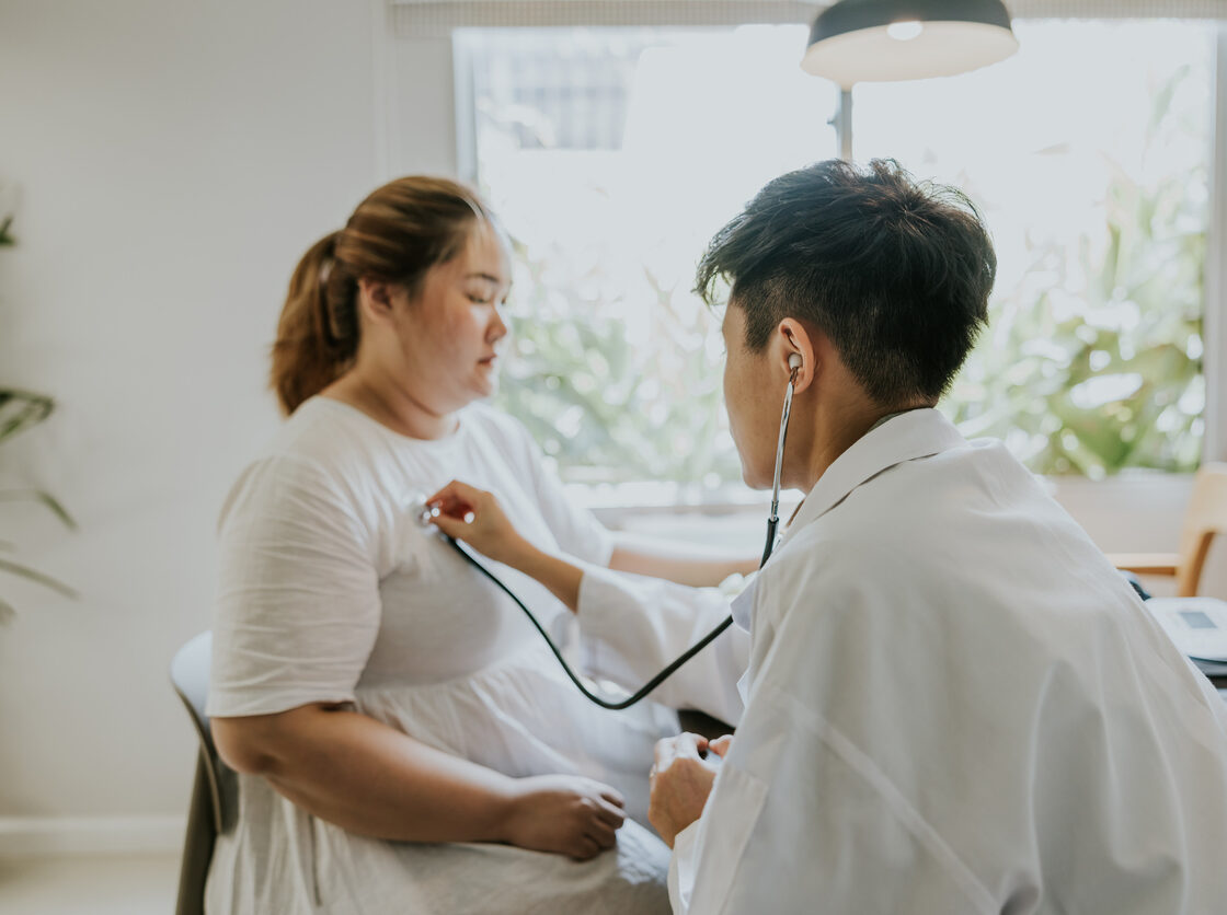 Asian man doctor listening patient heartbeat before staring consult on nutrition for overweight person.