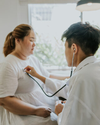 Asian man doctor listening patient heartbeat before staring consult on nutrition for overweight person.