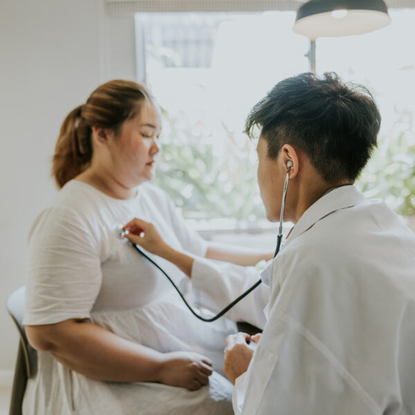 Asian man doctor listening patient heartbeat before staring consult on nutrition for overweight person.