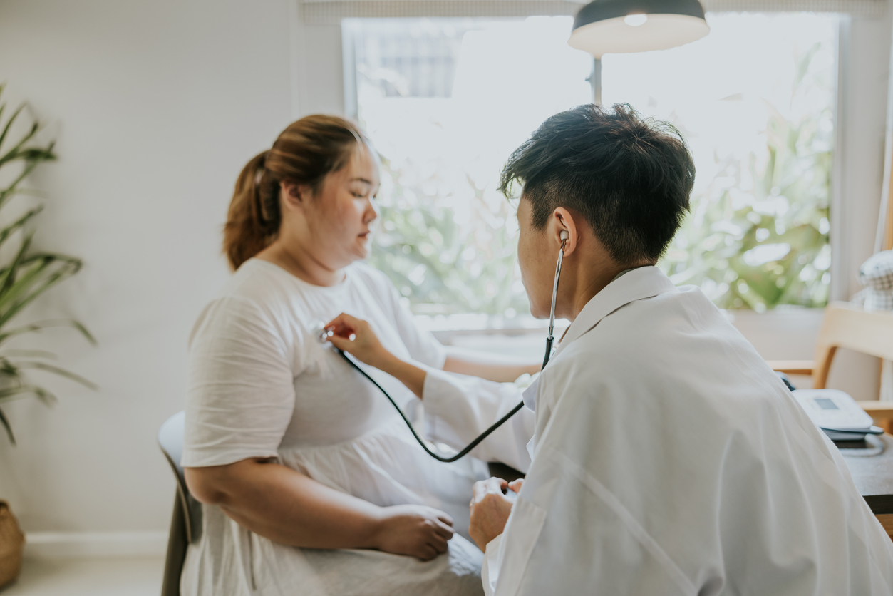 Asian man doctor listening patient heartbeat before staring consult on nutrition for overweight person.