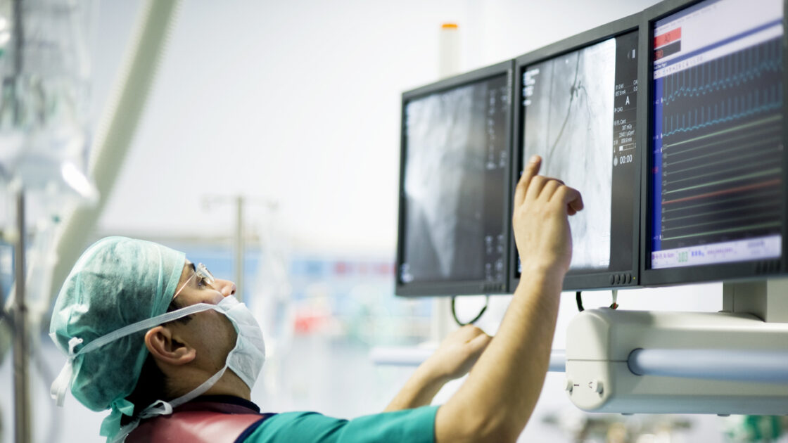 Cardiologist doctors are in a angio operation, one of the doctors following the LCD screens for the stent... ( real life )