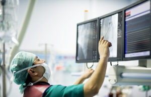 Cardiologist doctors are in a angio operation, one of the doctors following the LCD screens for the stent... ( real life )