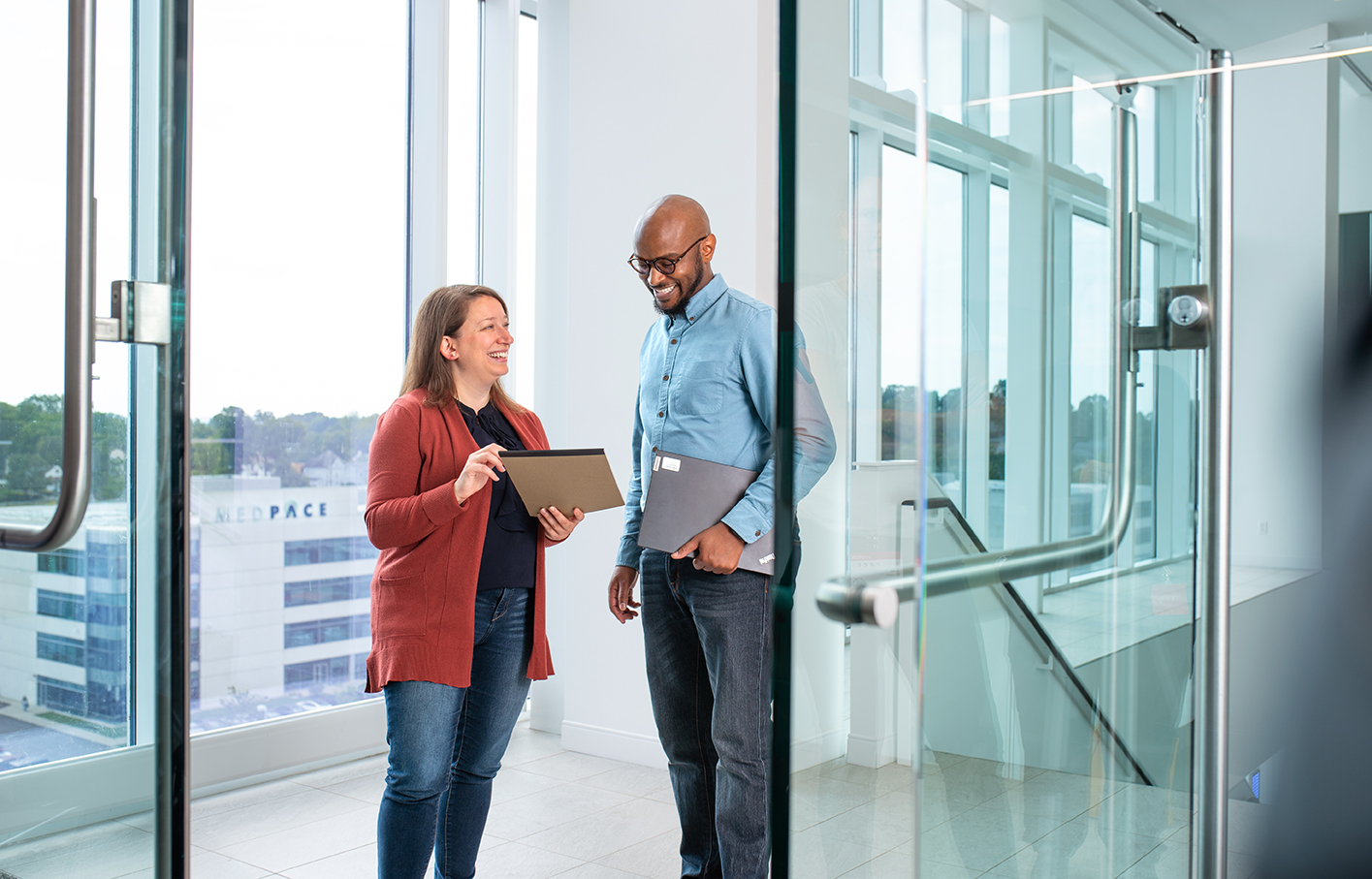 2 people talking in office building
